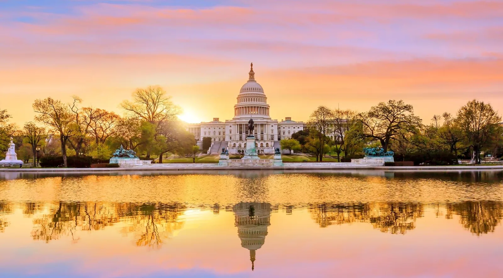 The U.S. Capitol reflected in the Capitol Reflecting Pool at sunrise