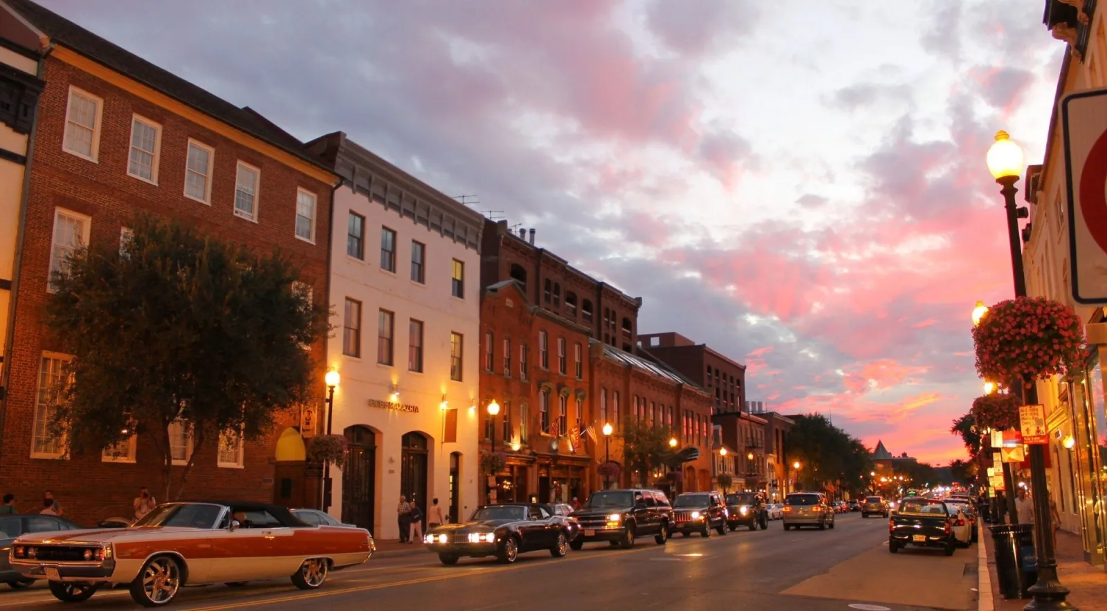 Brick row houses and shops on a historic street at dusk