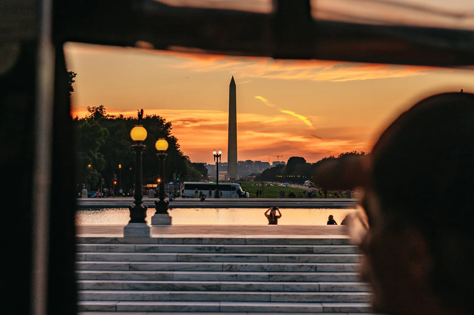 The Washington Monument at sunset seen through a trolley window