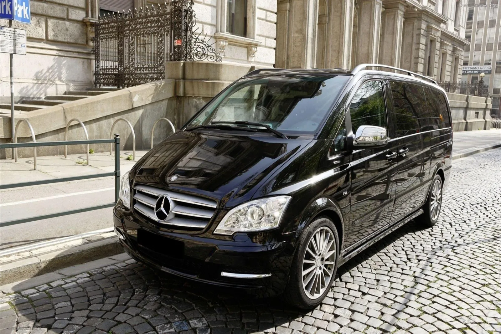 Black private Mercedes van parked on a cobbled Washington street