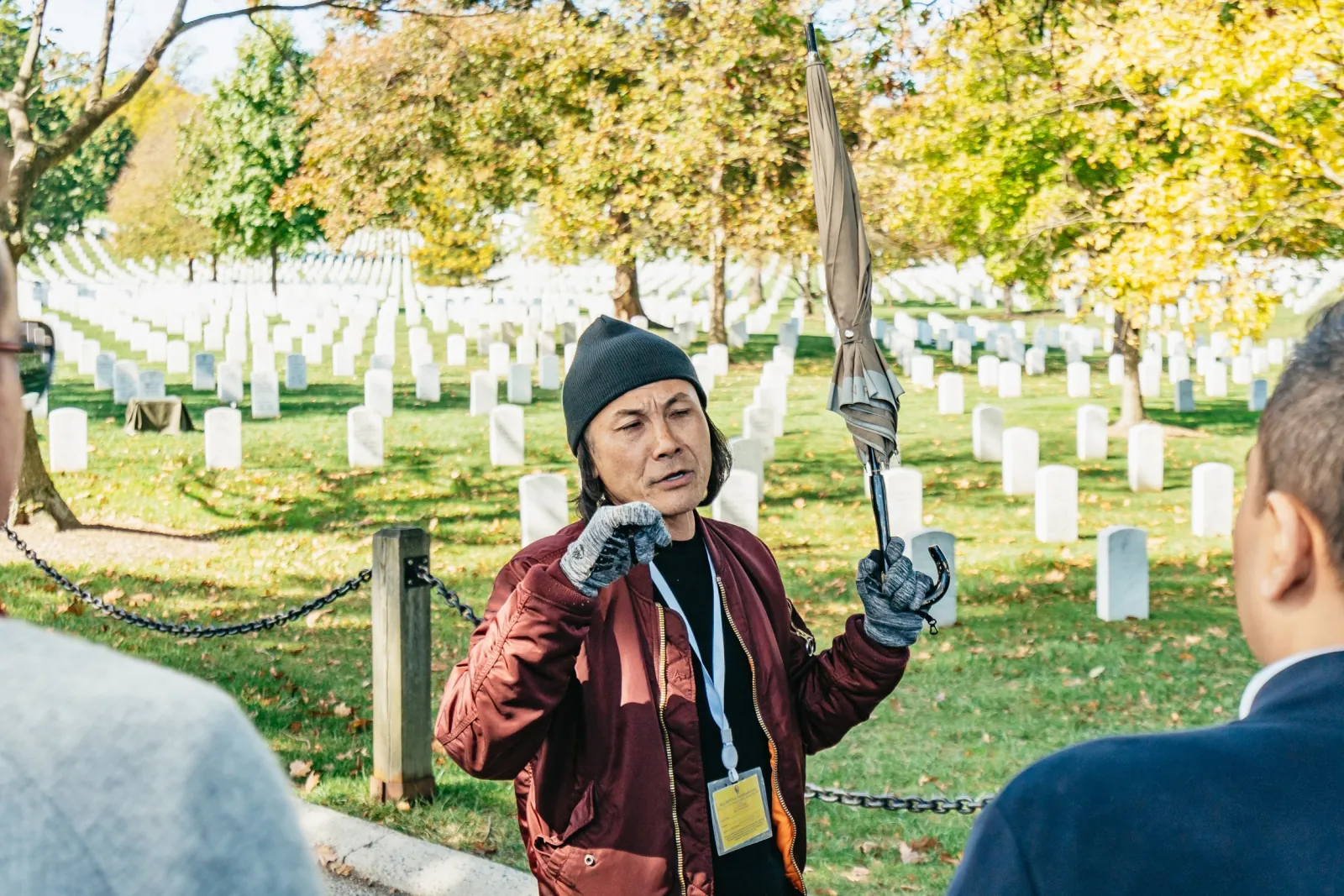 A guide talking to the group among the headstones at Arlington National Cemetery