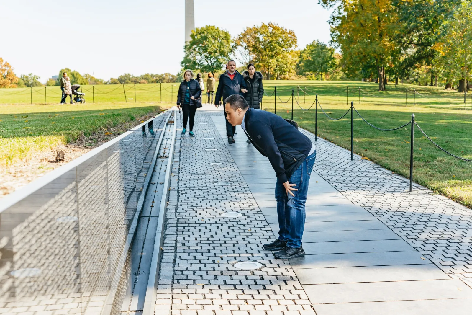 Visitors reading the names on the Vietnam Veterans Memorial wall